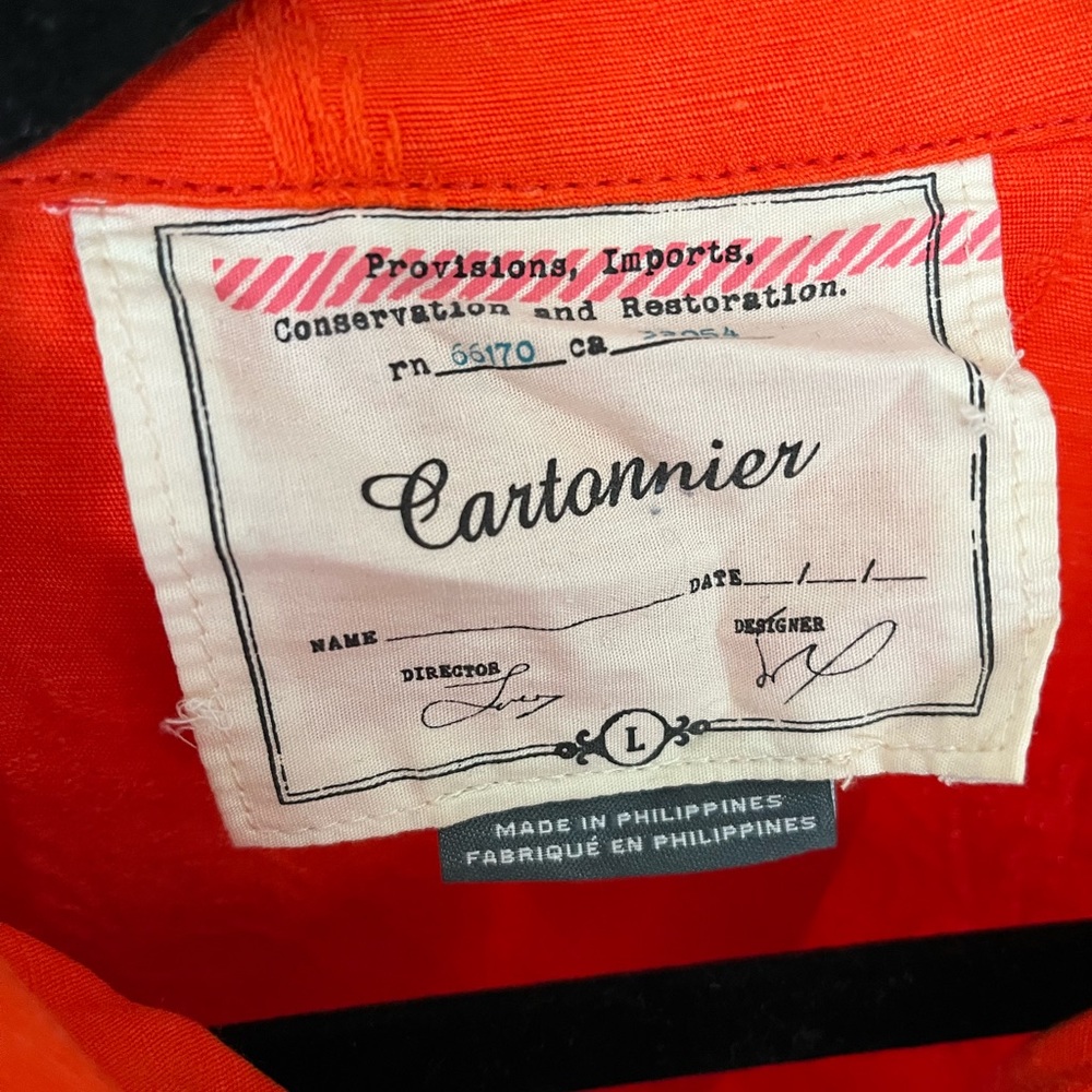 Bright orange Anthropologie Cartonnier cropped jacket.